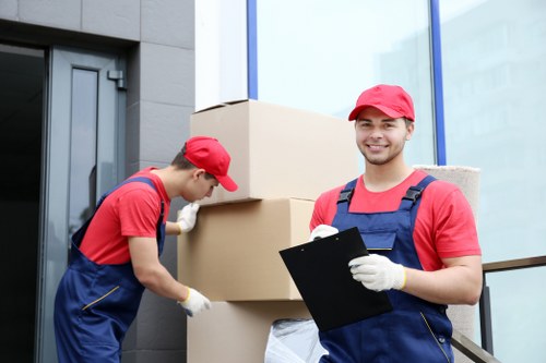 Removal crew loading furniture into a moving vehicle