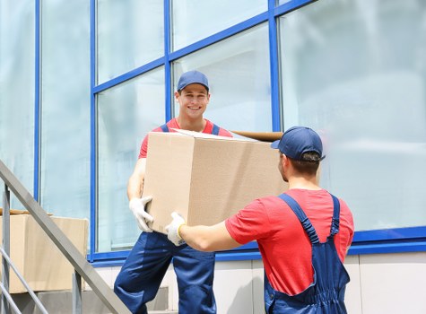 Movers Hounslow team sorting recyclable moving materials at a home removal