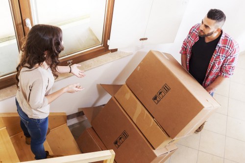 Professional movers handling boxes and furniture in West London