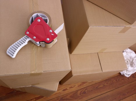 Office relocation logistics with furniture and boxes prepared for transport