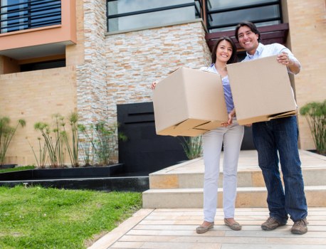 Movers transporting office equipment during a business relocation in Hounslow